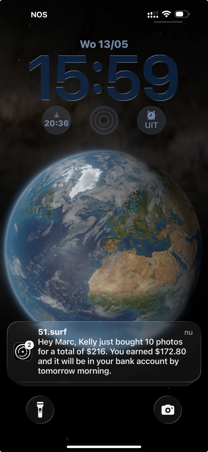 iPhone lock screen with a 51.surf push notification showing a sale and the photographer's earnings